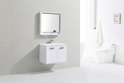 Modern bathroom with white vanity, mirror, and toilet against a light gray wall.