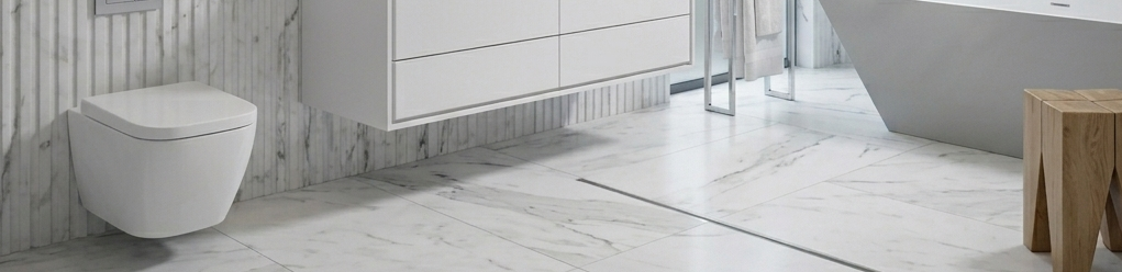 Modern white wall-hung toilet mounted on a tiled wall with open floor space underneath, showcasing a clean minimalist bathroom design.